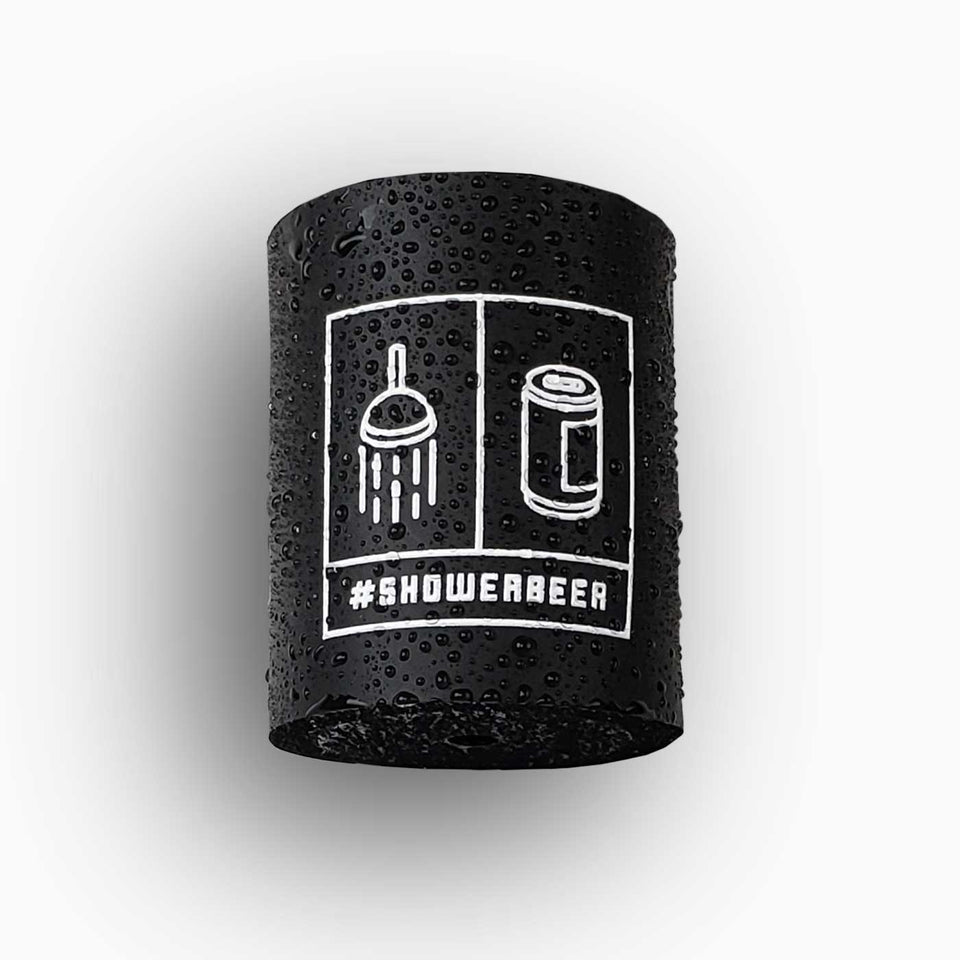 Foam can beverage holder that sticks to shower wall via industrial velcro. This design is white ink printed on a black can holder with the words "#SHOWERBEER" written across the bottom and the artwork depicting a shower head and a canned beer beverage.